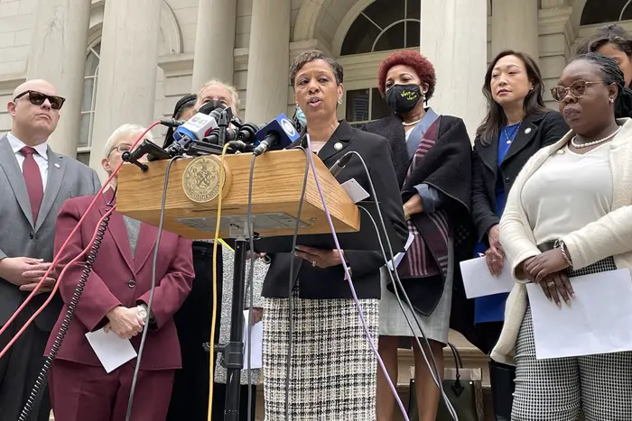 New York City Council Speaker Adrienne Adams at the podium flanked by chairs of various Council committees calling on $1.3 billion in more funding into the budget.